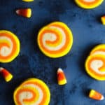 candy corn cookies and candy corn laid out against a dark backdrop