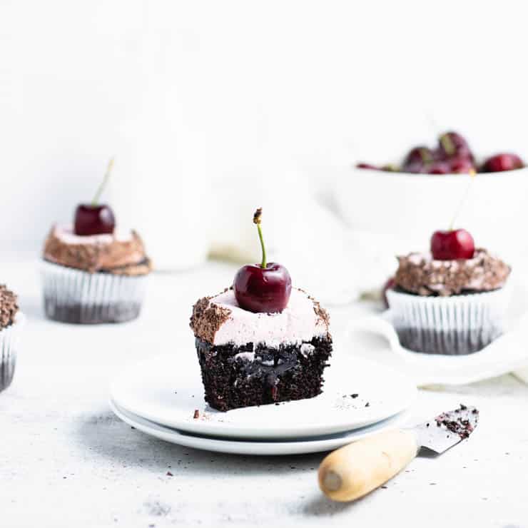 chocolate cherry cupcake cut in half to reveal cherry filling.