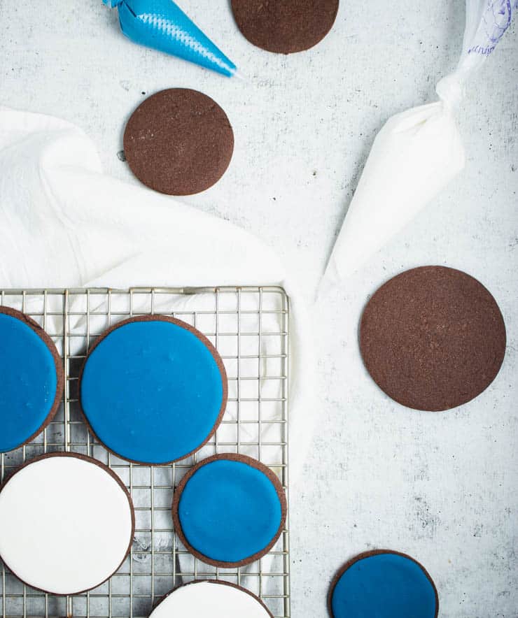 overhead photo of cookies with white and blue royal icing