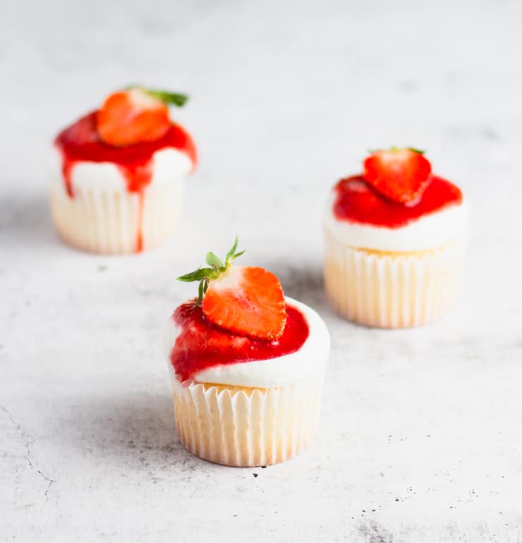 close up photo of three strawberry shortcake cupcakes