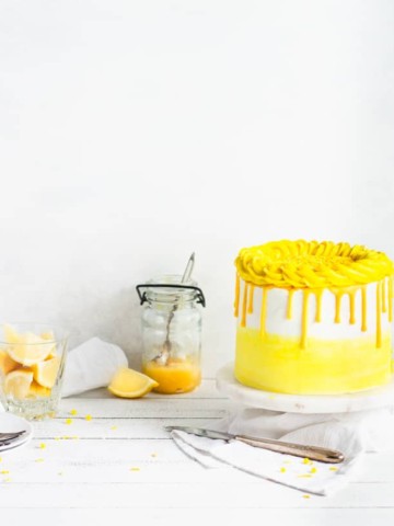 cake with a jar of lemons and lemon curd in the background