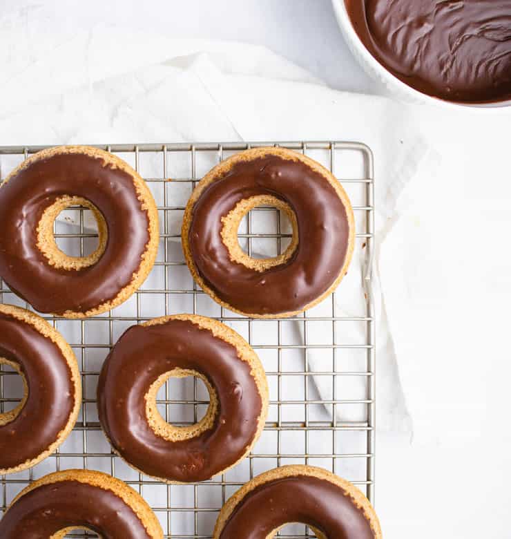 chocolate glazed doughnuts on a cooling rack