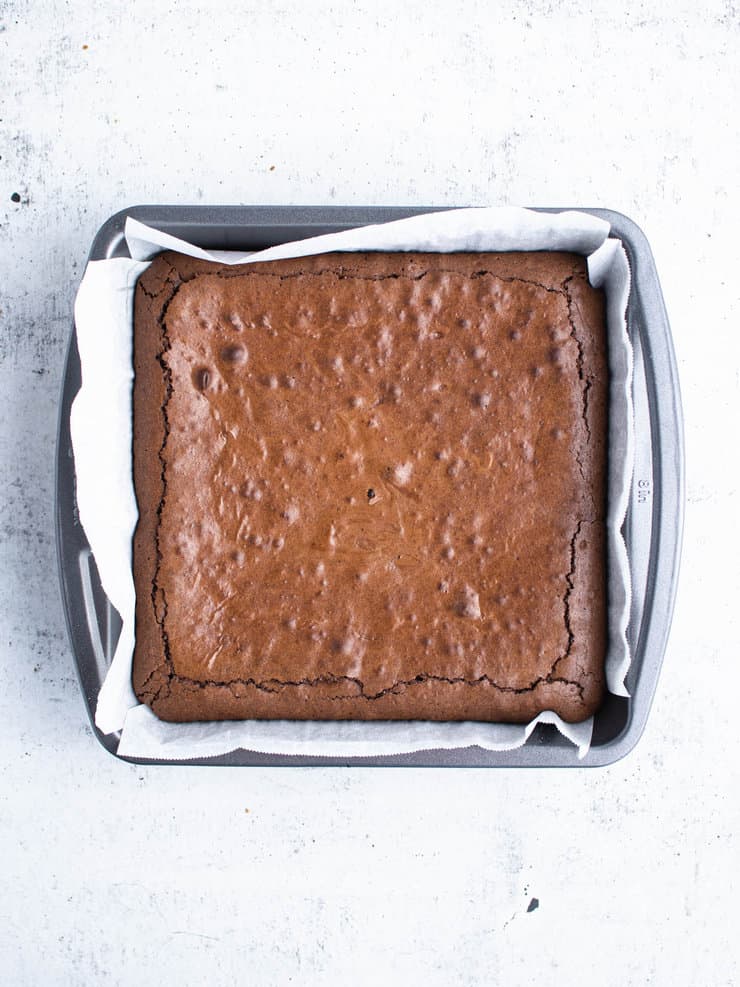 Overhead view of baked brownies in a square, silver pan.