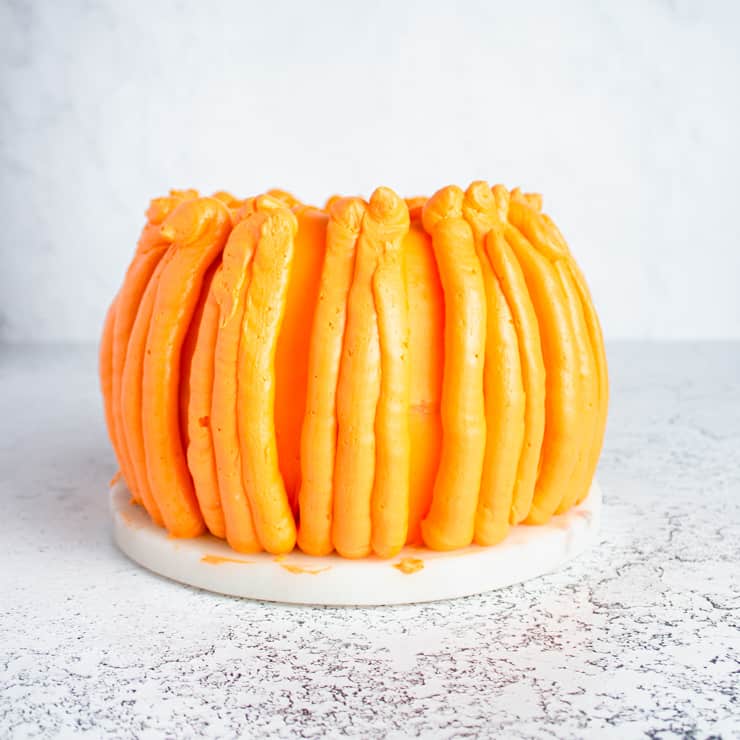 frosting piped onto cake to look like pumpkin ridges