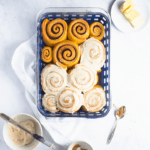baked cinnamon rolls that are partially iced