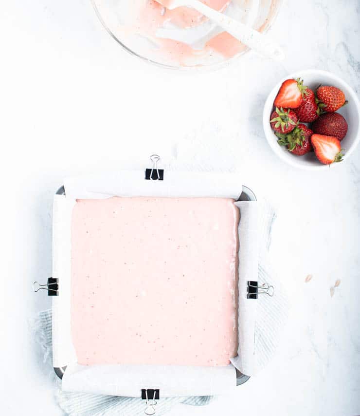 overhead view of strawberry cake batter in a square pan