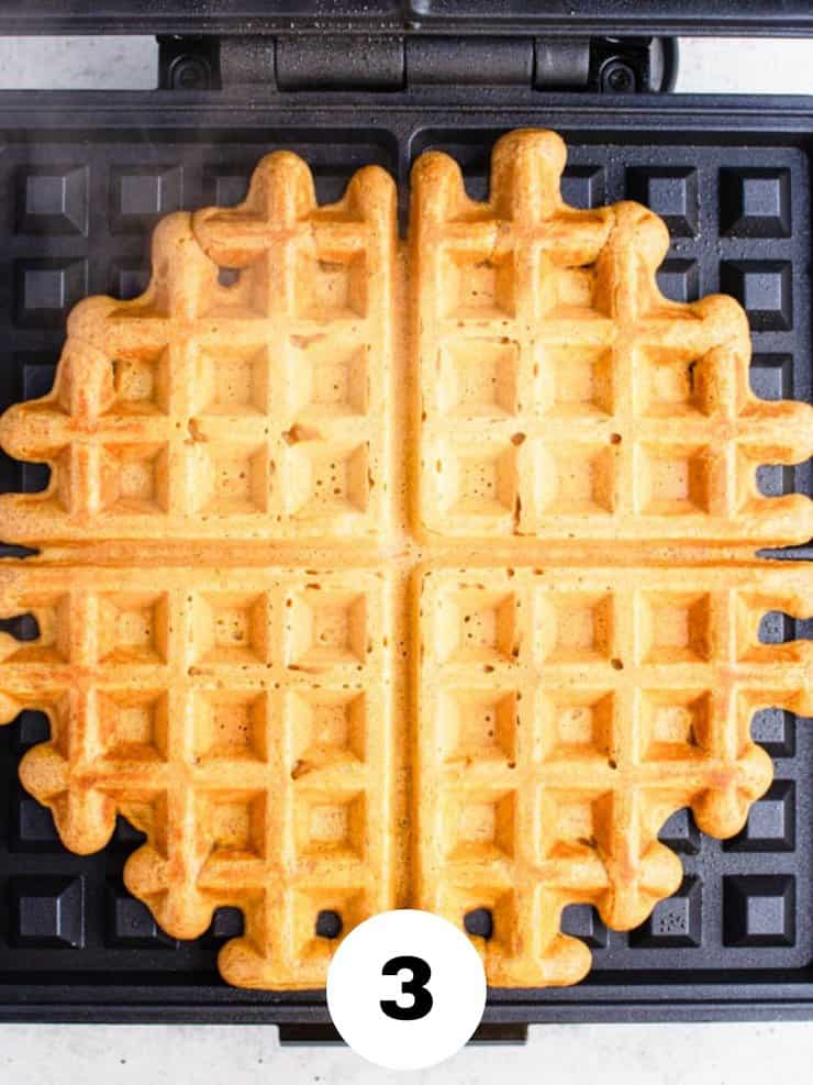 Overhead view of cooked waffle on a waffle iron.
