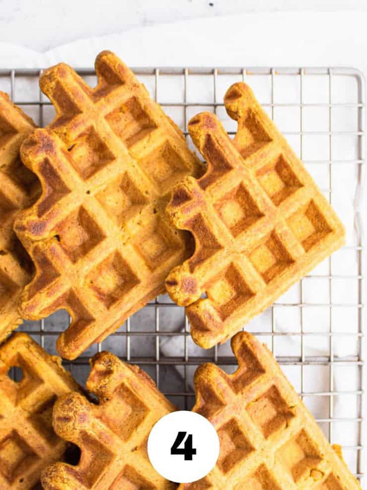 Overhead view of pumpkin waffles on a cooling rack.