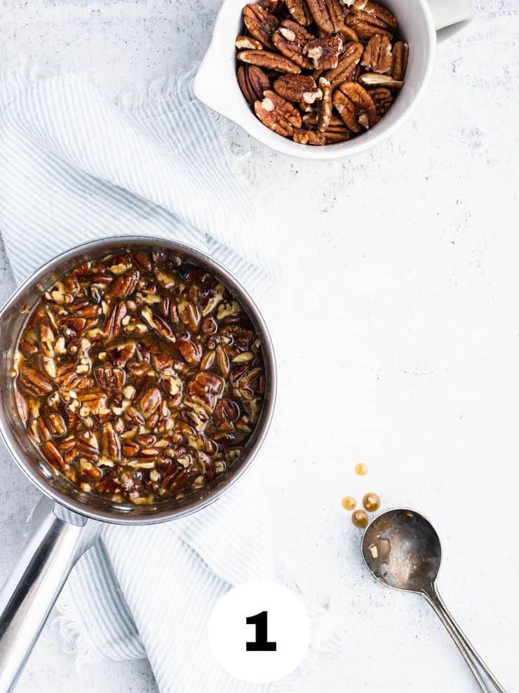 small pot with warm pecan topping for a pecan upside down cake.