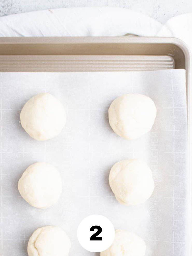 balls of lefse dough on a baking sheet.