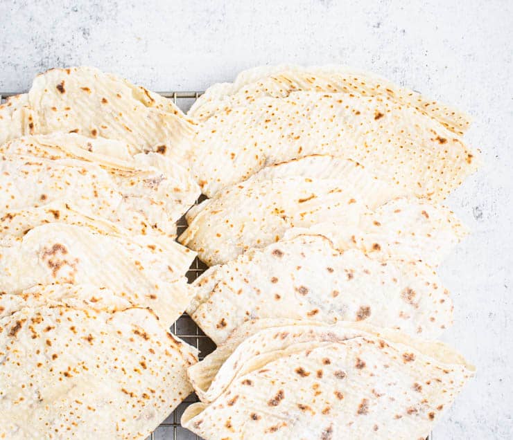 folded layers of lefse on a cooling rack.