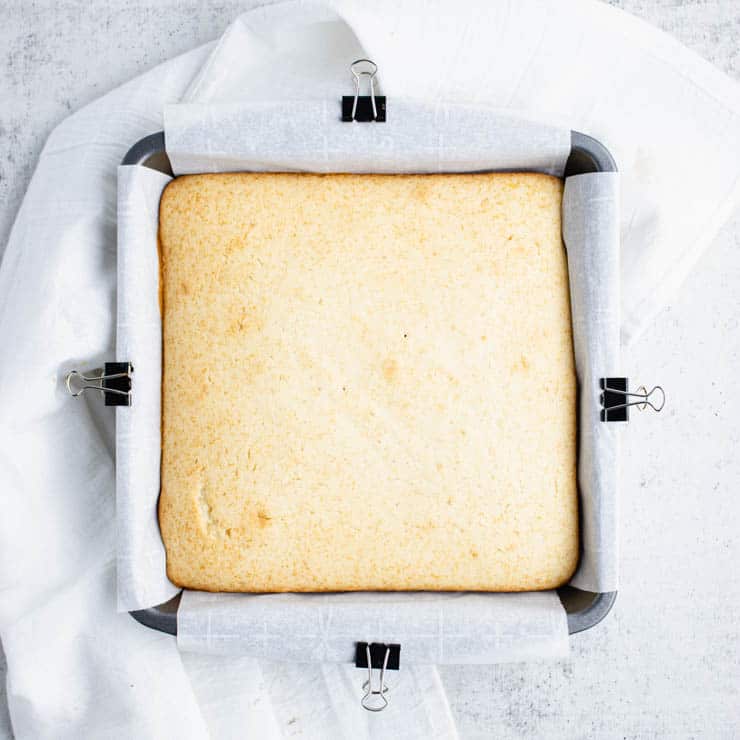 Overhead view of an eggnog cake in a square 8x8 pan.
