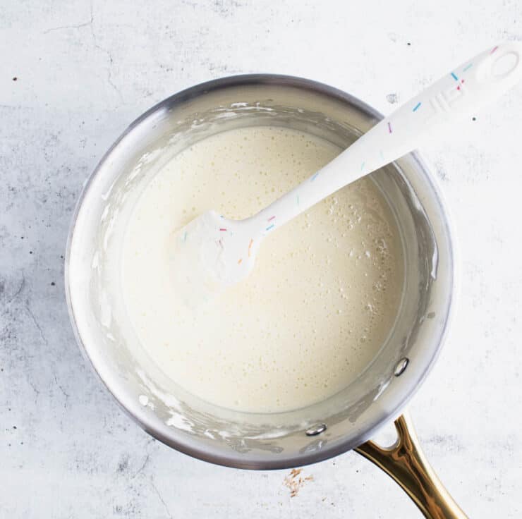 overhead view of melted marshmallows, butter and sweetened condensed milk in a large pot.