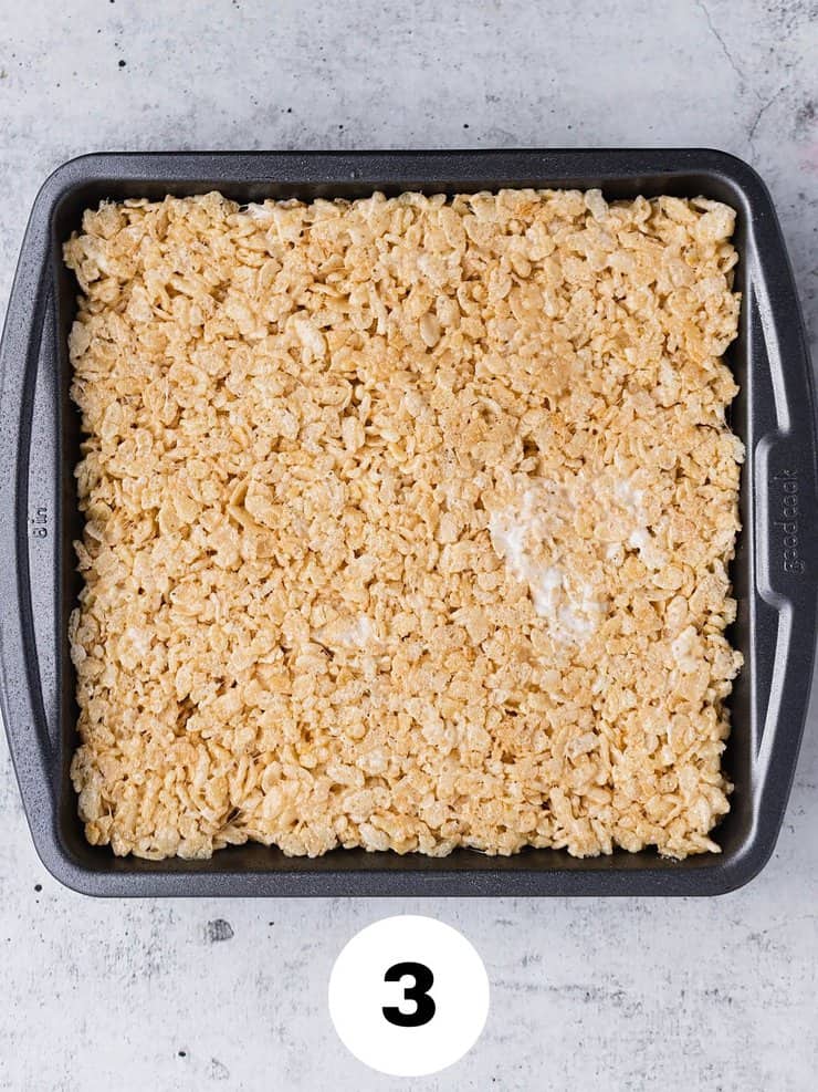 Step three: Overhead view of browned butter rice krispie treats pressed into an 8x8 pan.