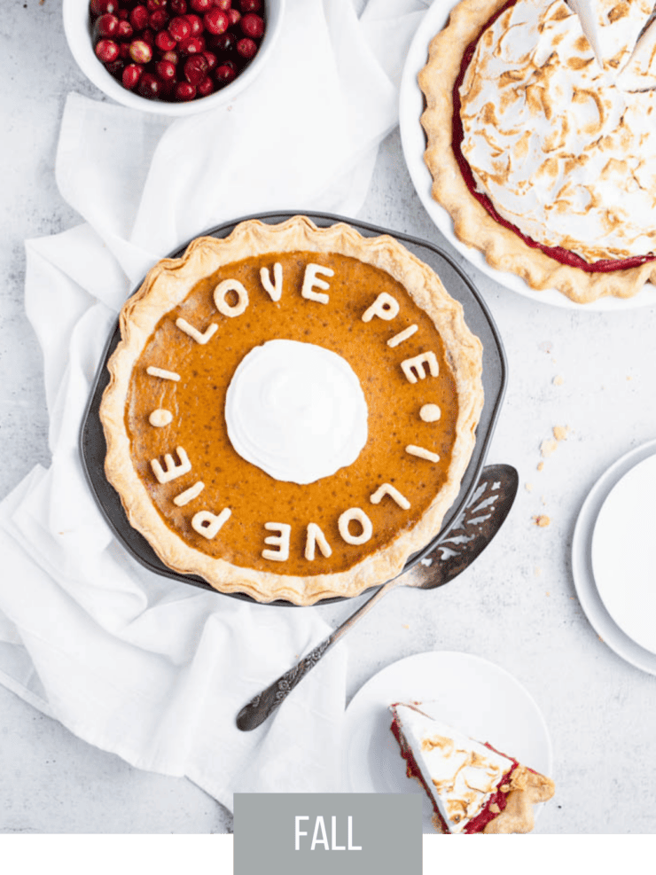 Overhead view of orange pumpkin pie with pie dough crust words spelling "I love pie" across the top.